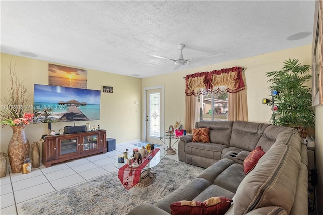 tiled living room featuring ceiling fan and a textured ceiling