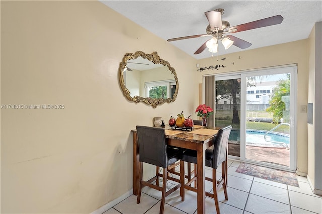 dining room with ceiling fan and light tile patterned flooring