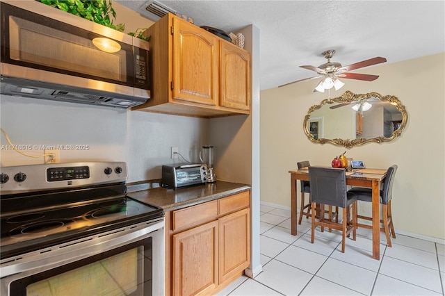 kitchen with ceiling fan, light tile patterned flooring, and appliances with stainless steel finishes