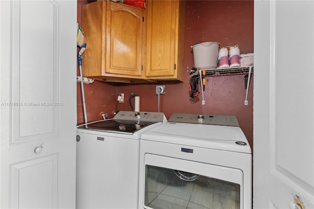 washroom featuring cabinets and washing machine and dryer