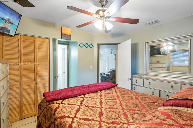 tiled bedroom with a closet and ceiling fan