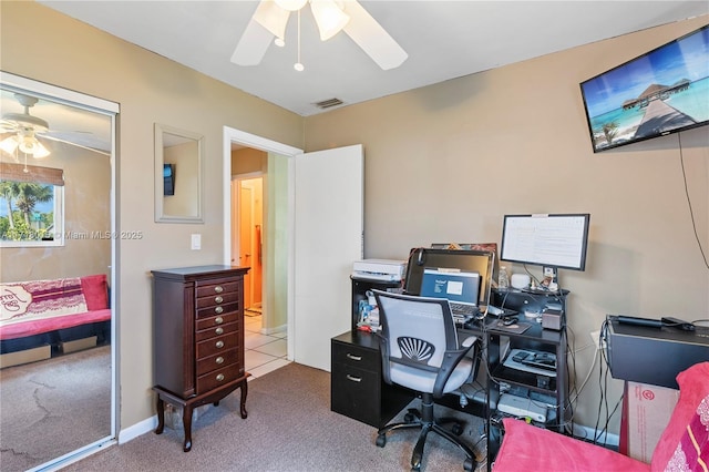 carpeted home office with ceiling fan