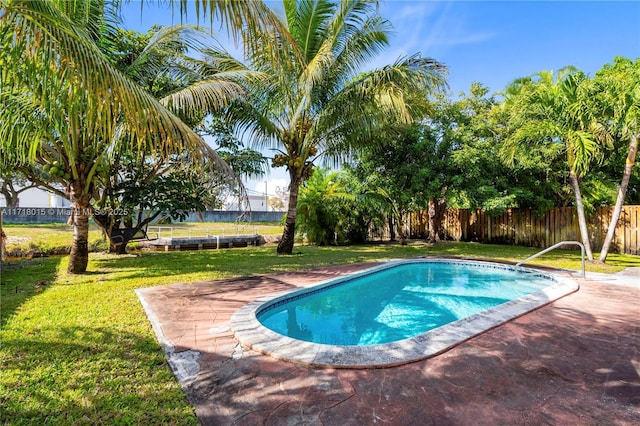 view of swimming pool with a yard and a patio