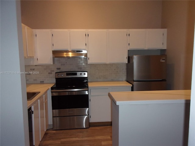 kitchen with white cabinets, stainless steel appliances, and tasteful backsplash