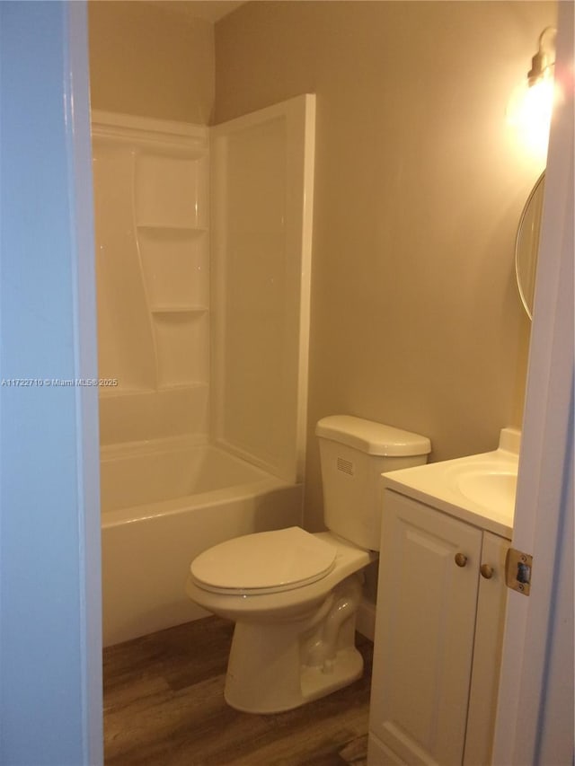 full bathroom featuring toilet, shower / washtub combination, vanity, and hardwood / wood-style floors