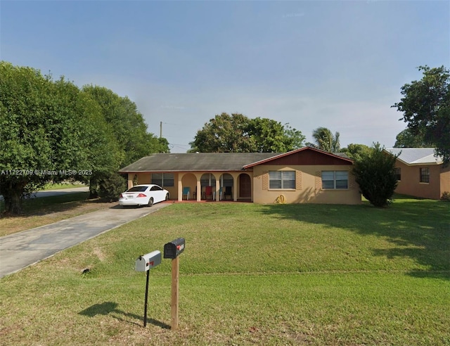 ranch-style home with a front lawn and driveway