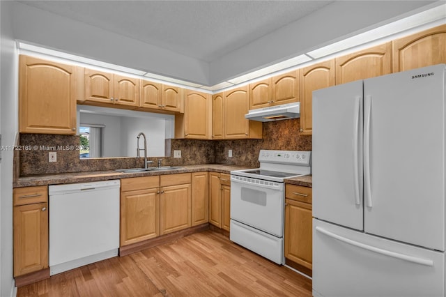 kitchen with white appliances, light brown cabinetry, light hardwood / wood-style floors, tasteful backsplash, and sink