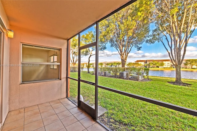 unfurnished sunroom with a water view