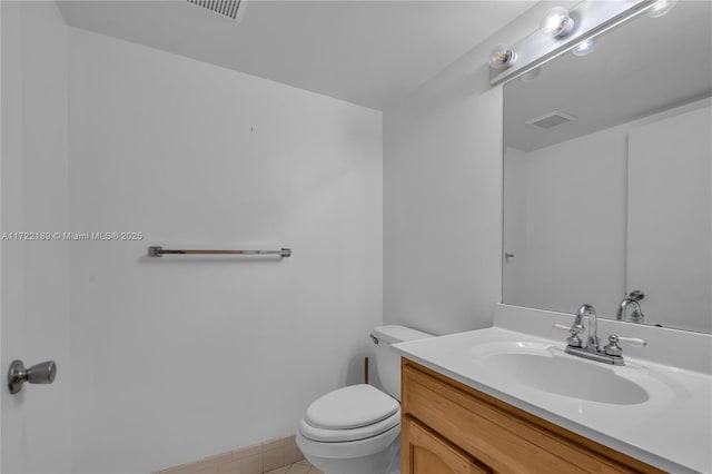 bathroom with vanity, toilet, and tile patterned flooring