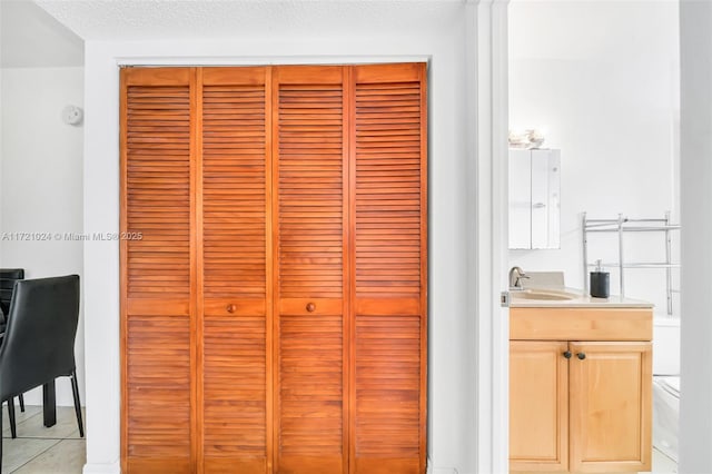 details featuring a textured ceiling and sink