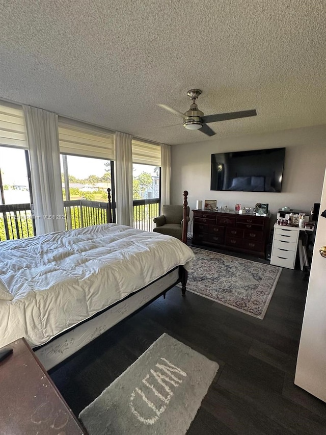 bedroom with ceiling fan, a textured ceiling, and dark wood-type flooring