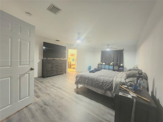 bedroom with visible vents, ceiling fan, and wood finished floors