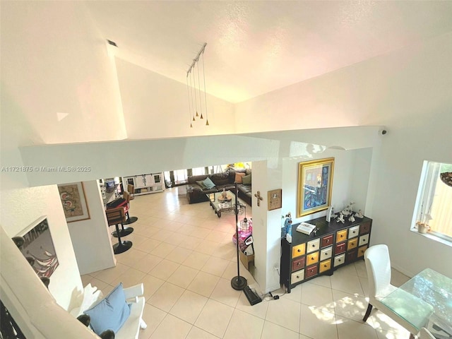 interior space with vaulted ceiling and tile patterned flooring