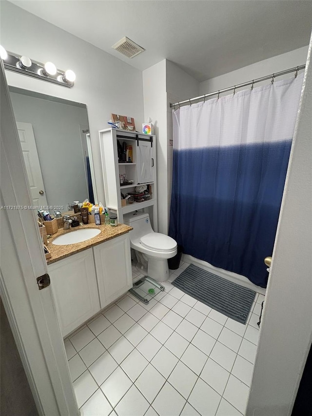 bathroom with tile patterned flooring, visible vents, vanity, and toilet