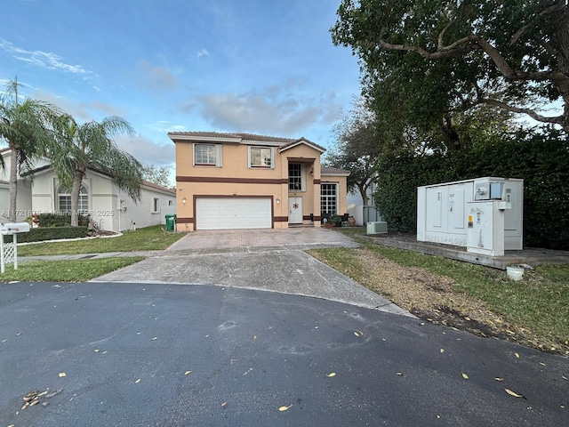 view of front of home featuring a garage, concrete driveway, and stucco siding