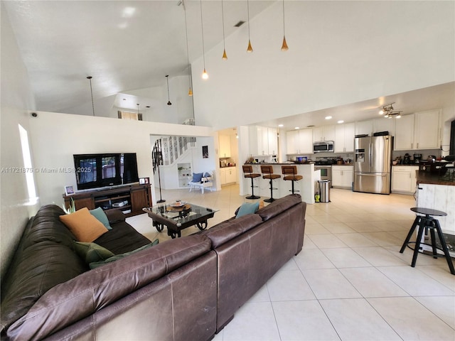 5323 NW 109th Ct, Doral, FL 33178 - living room featuring light tile patterned floors, stairs, and high vaulted ceiling
