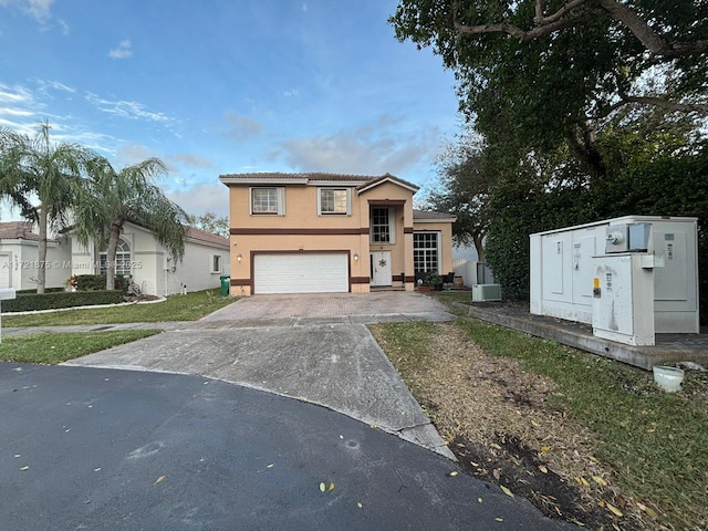 5323 NW 109th Ct, Doral, FL 33178 - tri-level home with a tile roof, central air condition unit, stucco siding, driveway, and an attached garage