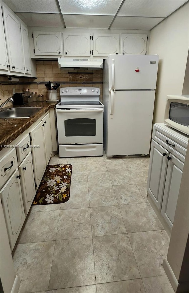 kitchen with white cabinets, white appliances, tasteful backsplash, and a drop ceiling