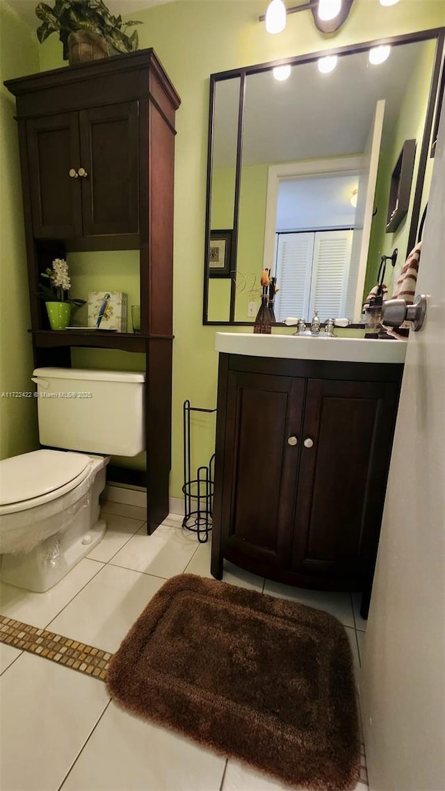 bathroom with tile patterned floors, vanity, and toilet