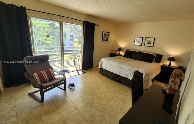 bedroom featuring access to outside and a textured ceiling