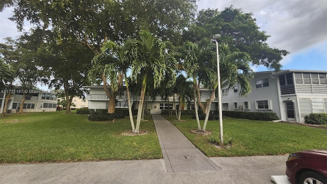 view of property's community featuring a yard