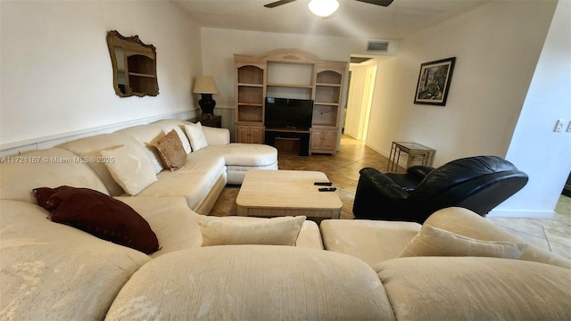 living room with ceiling fan and light tile patterned floors