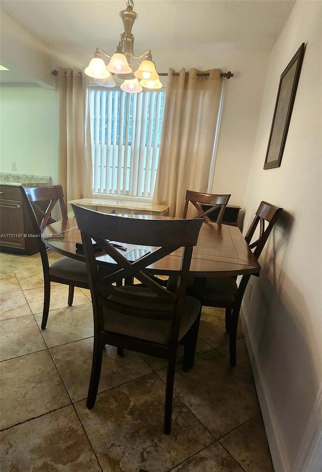 tiled dining room with an inviting chandelier