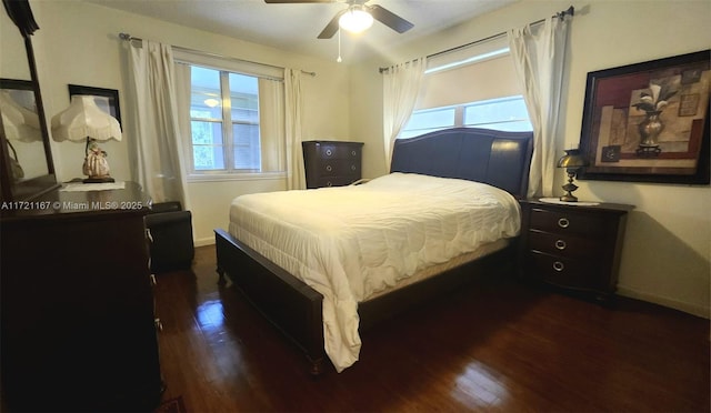 bedroom with ceiling fan and dark hardwood / wood-style flooring