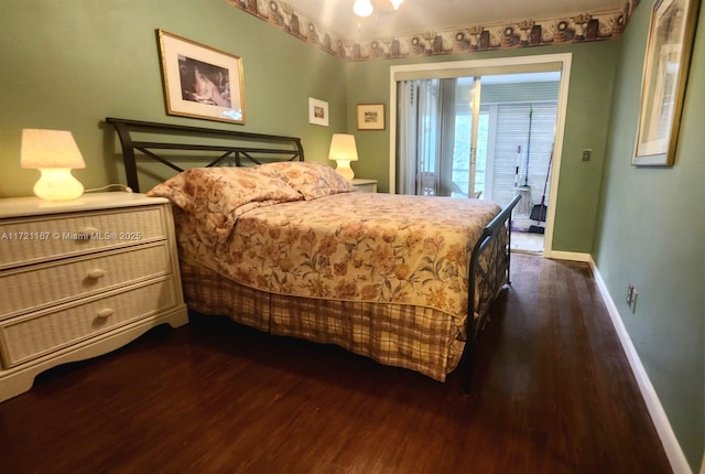 bedroom with dark wood-type flooring and access to outside