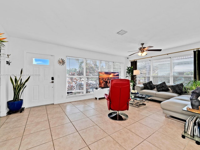 tiled living room featuring plenty of natural light and ceiling fan