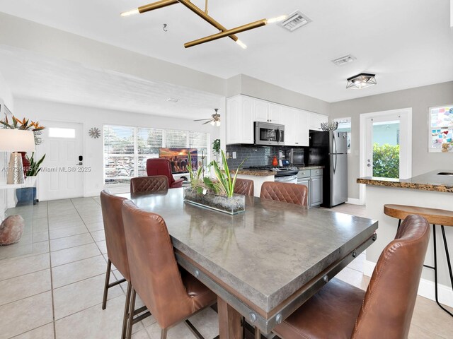 kitchen with stainless steel appliances, white cabinetry, a breakfast bar area, and sink