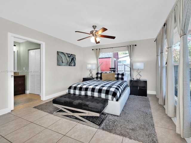 tiled bedroom featuring ceiling fan