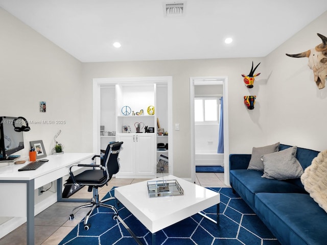 office featuring built in shelves and tile patterned floors