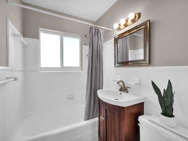 full bathroom with vanity, tile walls, shower / bath combo, and toilet