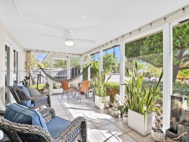 sunroom with plenty of natural light and ceiling fan