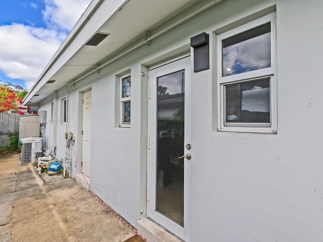 view of side of home with a patio and central AC