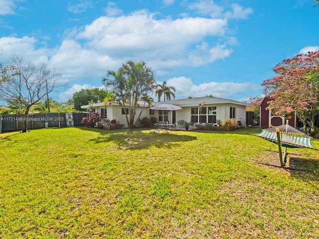 rear view of property with a yard