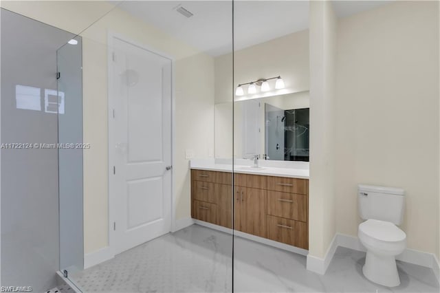 bathroom with a shower with door, vanity, and toilet