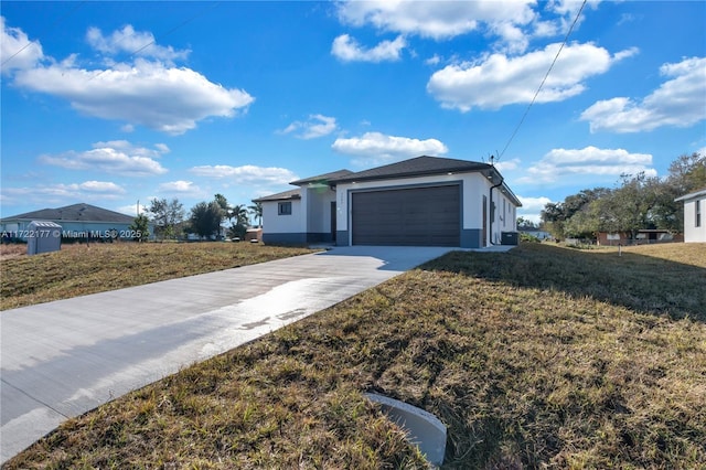 view of front of property with a front yard and a garage