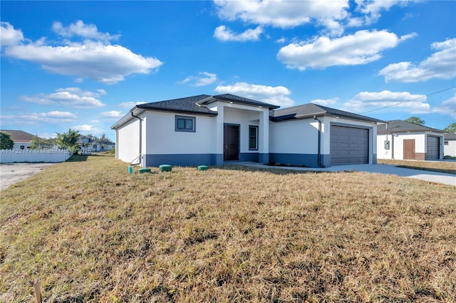 view of front of house featuring a garage and a front lawn