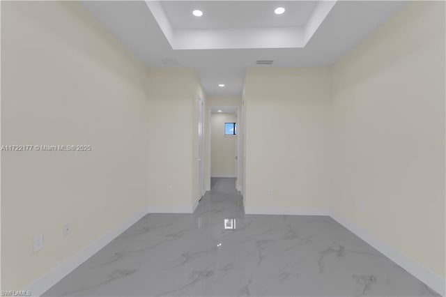 hallway with a tray ceiling