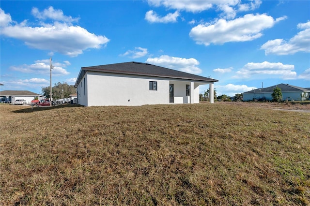 rear view of property with a lawn