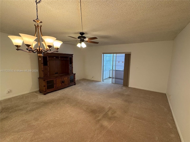 unfurnished living room featuring carpet floors, ceiling fan with notable chandelier, and a textured ceiling