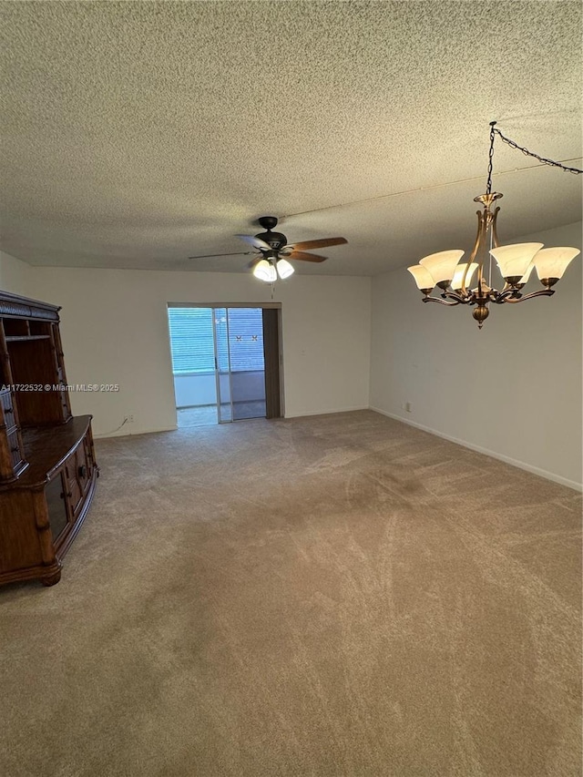 unfurnished living room with a textured ceiling, carpet flooring, and ceiling fan with notable chandelier