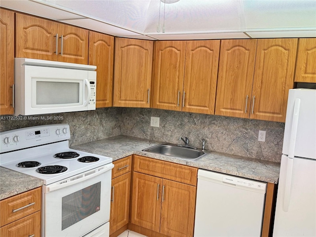 kitchen featuring sink, white appliances, and backsplash