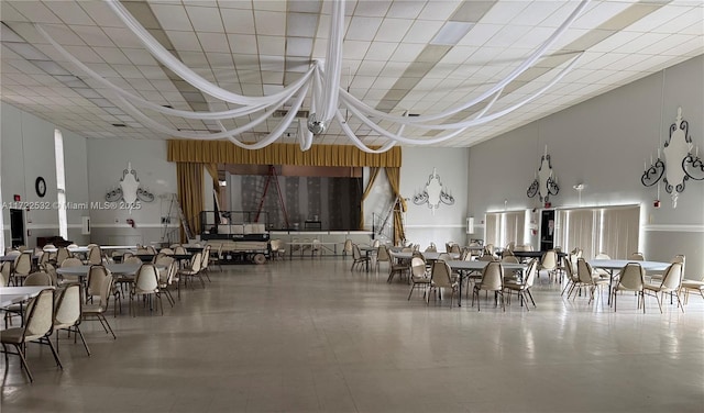 dining area with a towering ceiling