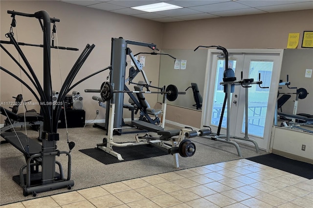 exercise room featuring a paneled ceiling