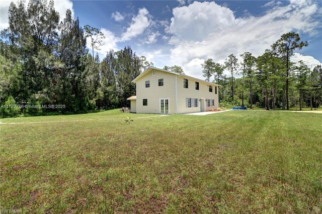 rear view of property featuring a yard