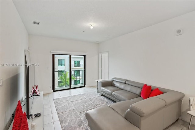 living room with light tile patterned floors and a textured ceiling