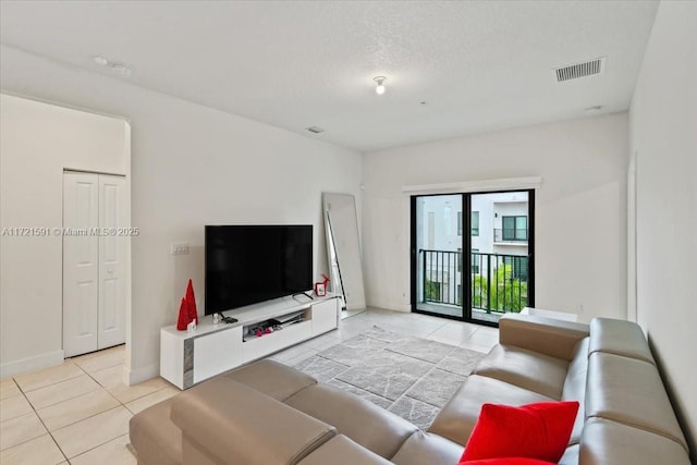 living room featuring light tile patterned floors and a textured ceiling